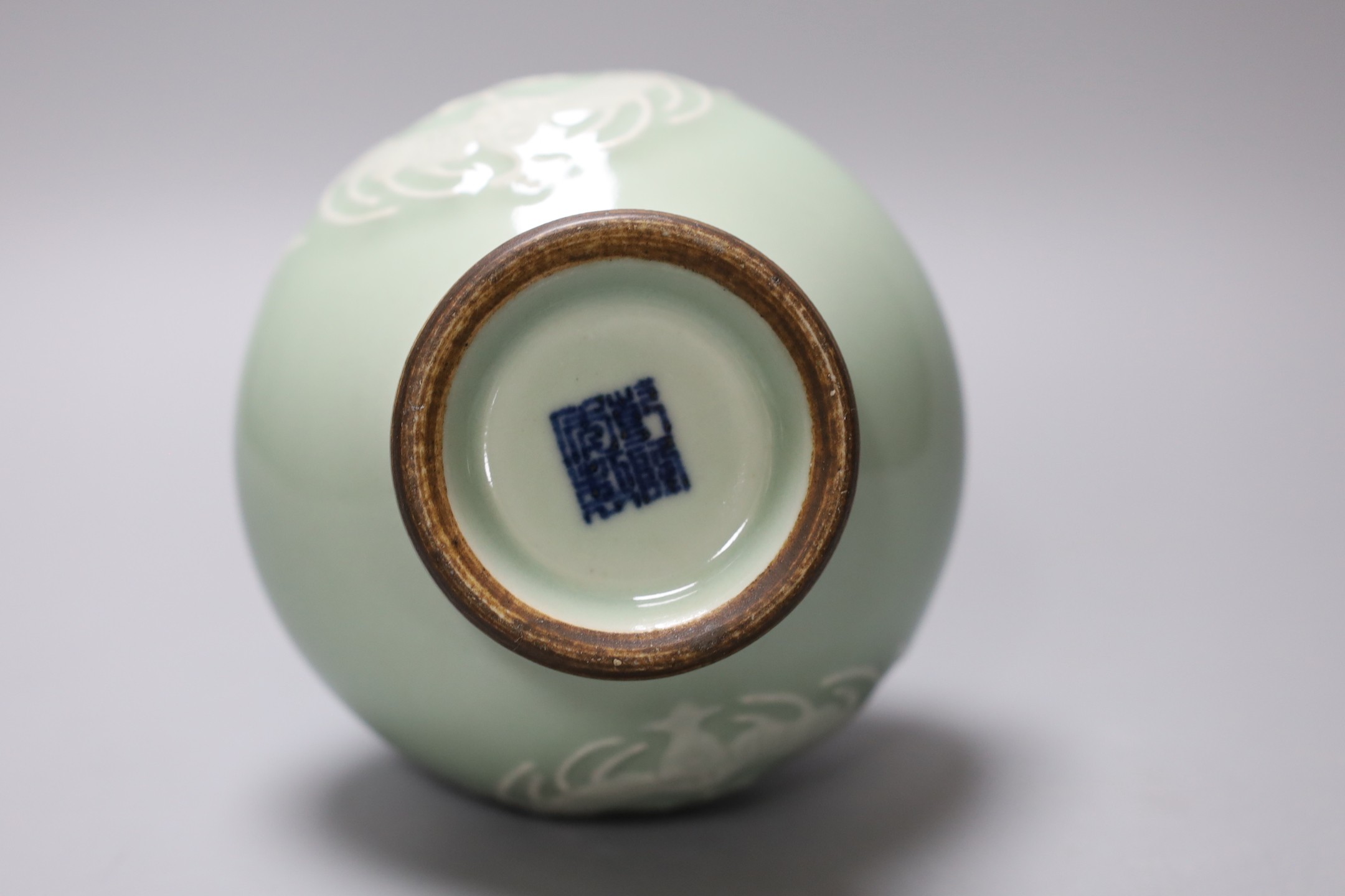 A Chinese celadon two handled vase with slip decoration, 15cm tall